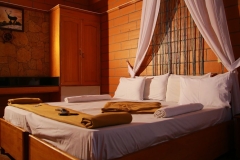 Relaxing ambiance with tastefully decorated bed and stylish furniture in Nest Inn Resort.