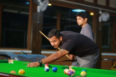 Energetic game of pool in the lively indoor games room at The Nest Inn Resort.