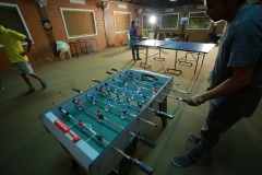 Guests enjoying a friendly game of table tennis in the vibrant indoor games area.